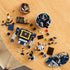 LEGO Icons Soundwave 10358 build in progress with scattered blue and gray LEGO pieces, showcasing partially built robot, cassette builds, and organized components on a wooden tabletop.
