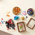 Assorted LEGO mineral pieces spread across a table, including colorful translucent orange, purple, and blue crystal bricks and rectangular brown frame components.