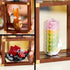Detailed close-up of LEGO Ideas Mineral Collection showing vibrant orange, red, and rainbow-colored crystal formations built from translucent LEGO pieces on brown display stands.