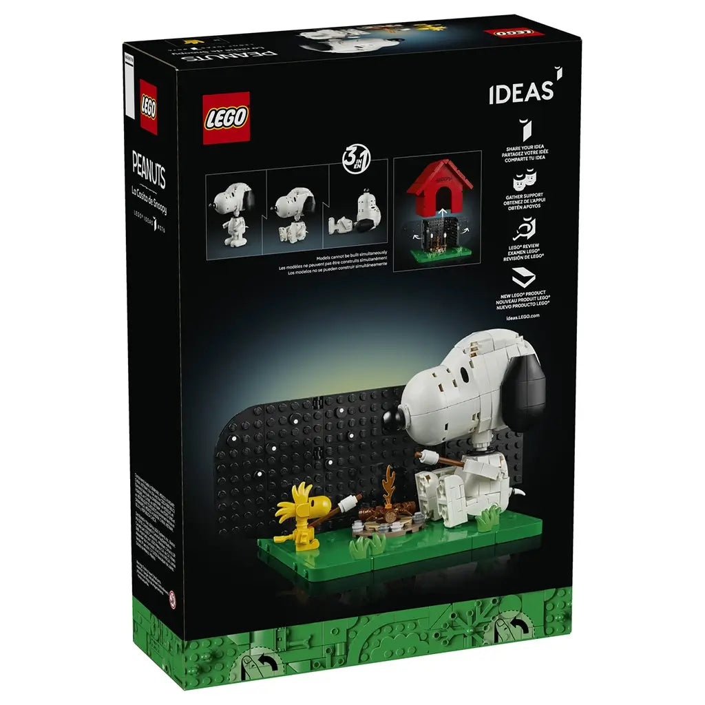 LEGO Ideas Snoopy's Doghouse box back shows white Snoopy and yellow Woodstock on a green brick base, with alternate Snoopy poses, campfire scene and doghouse feature.