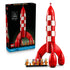 LEGO Ideas Tintin Moon Rocket building kit includes a red and white plastic rocket with rounded fins, astronaut minifigures and retail packaging, arranged on a white background.