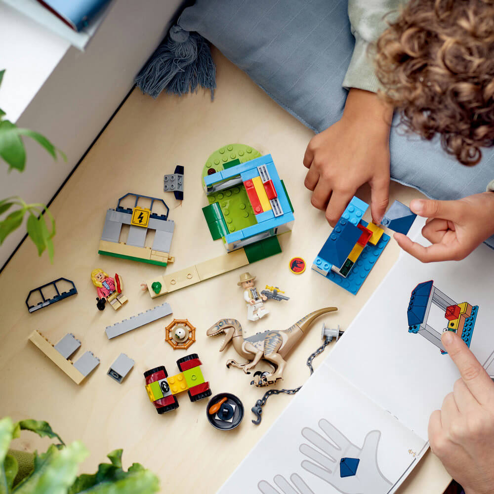 Boy building the LEGO® Jurassic World Velociraptor Escape 137 Piece Building Set