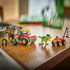 LEGO Jurassic World Young T. rex set displays a green dinosaur with food bait beside a red and gray transport truck, red ATV and two minifigures on a wooden table.