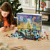 LEGO Marvel Advent Calendar 2026 playset is built by a child at a wooden table, with colorful superhero minifigures and mini builds spread before a snowy city calendar.