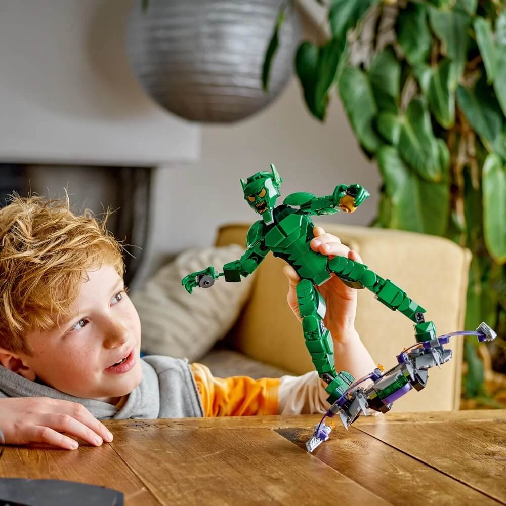 Boy playing LEGO® Marvel Green Goblin Construction Figure 471 Piece Building Set (76284)