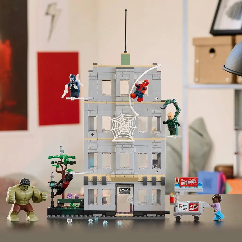 LEGO Marvel Spider-Man action set, gray plastic apartment-style building with web feature, Hulk, Spider-Man and villain minifigures displayed in a home setting beside a hot dog cart.