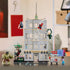 LEGO Marvel Spider-Man action set, gray plastic apartment-style building with web feature, Hulk, Spider-Man and villain minifigures displayed in a home setting beside a hot dog cart.