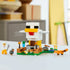 LEGO Minecraft Chicken Farm display showing completed white plastic chicken build with yellow legs, cubic block design for play and display, set on a green baseplate with animals and farm details.