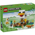 LEGO Minecraft Chicken Farm box front with green packaging showing white and yellow brick chicken model, smooth plastic block construction toy for kids, presented against a stylized Minecraft landscape background.