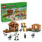 LEGO Minecraft Evoker Village Attack set 21596 in brown, tan and green bricks shows village builds, figures and mobs beside the green 607-piece product box on white.