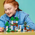 LEGO Minecraft First Night Adventure set features green, white and brown forest scenery with Alex, a Creeper, skeleton and animals as a child plays at a table.
