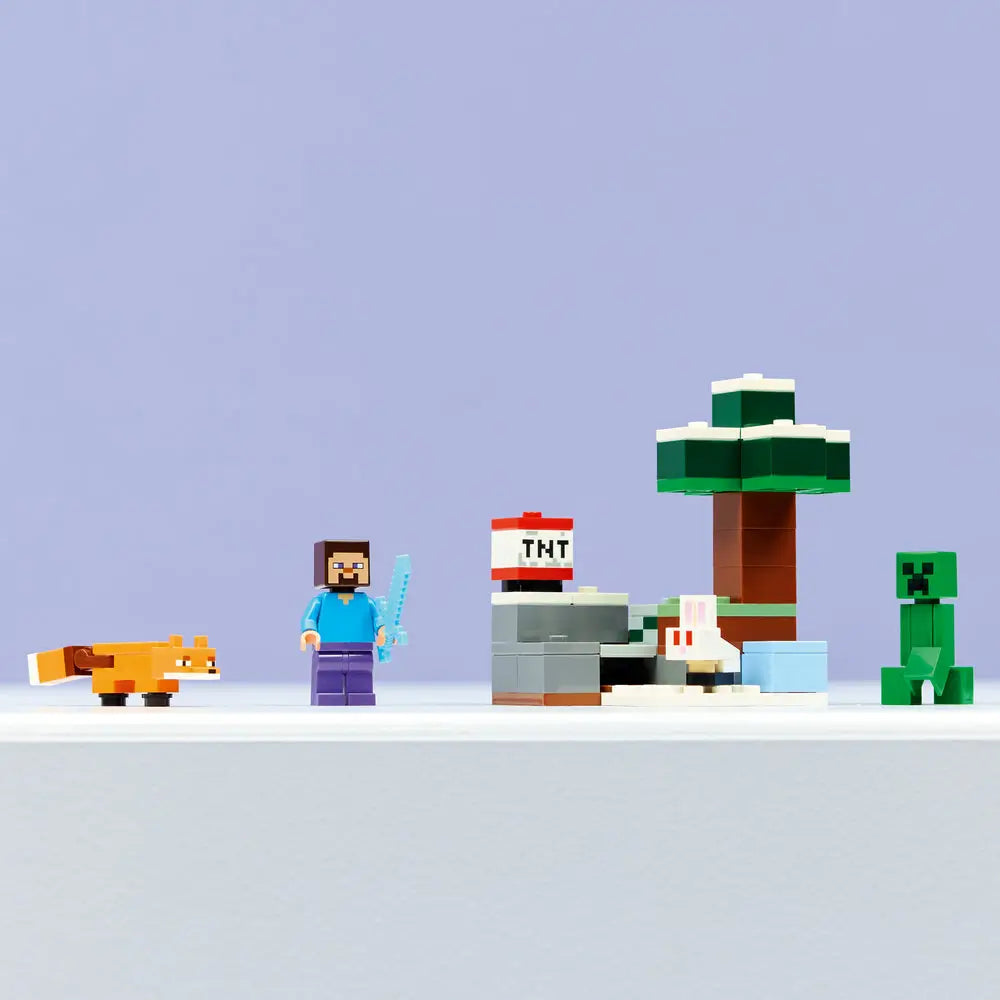 LEGO Minecraft Steve’s Taiga Adventure display showing completed plastic brick taiga scene with tree, snow base, and characters in green, white, and brown, cubic block design for play and display, lined up on a clean surface.