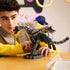 LEGO Minecraft The Ender Dragon model in black and gray bricks is adjusted by a child at a table, showing its articulated wings, segmented tail and dark display stand.