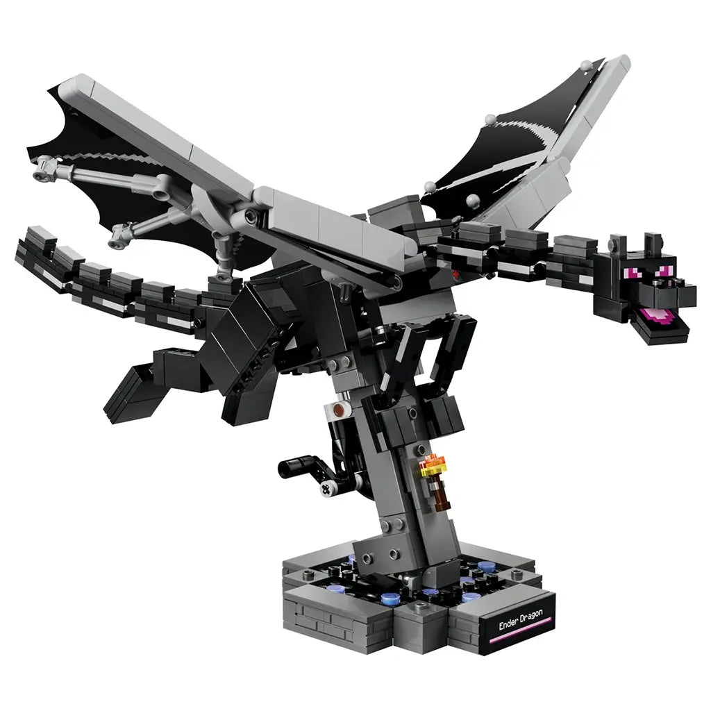 LEGO Minecraft The Ender Dragon model in black and gray bricks features broad articulated wings, a long segmented tail and purple eyes, posed on a dark display stand.