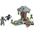 LEGO Minecraft The Pale Garden build features light gray and green plastic bricks forming a stone pillar structure with moss textures, grass tiles, flowers, and hostile mob figures arranged for imaginative play.