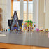 LEGO Despicable Me 4 playset in gray, black, green and yellow plastic bricks displays Gru’s mansion, treehouse, zip line, Minions and family figures on a tabletop.
