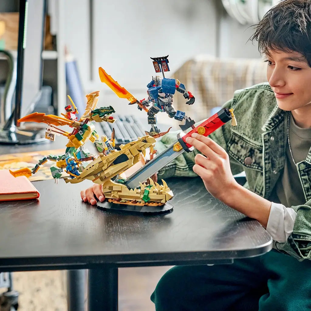 LEGO NINJAGO Battle at the Dragon's Blade in tan, gold, red and blue plastic is posed by a builder, with a dragon-head base, giant sword, flying dragon and warrior.