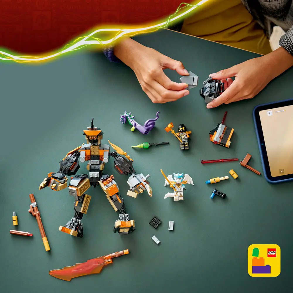 LEGO NINJAGO building toy scene with dark gray and gold mech parts on a green tabletop, jointed limbs, minifigures, and accessories shown mid-build to highlight hands-on construction and imaginative play.
