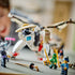 LEGO NINJAGO dragon toy in white, black, tan and gold plastic shows the Master Dragon's detailed head behind a green ninja minifigure holding a gold sword indoors.