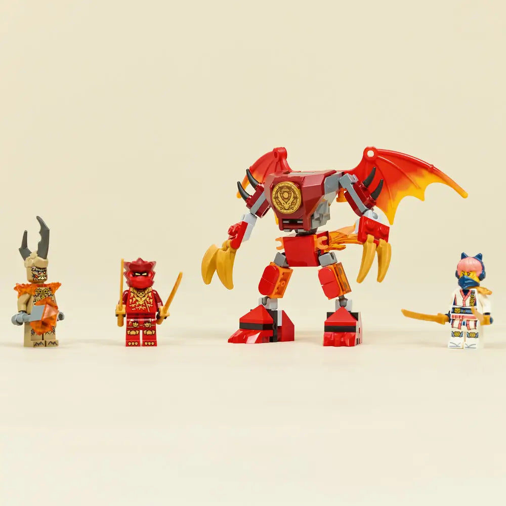 LEGO NINJAGO dragon mech stands upright in red and gray plastic with gold claws and wings, displayed beside three ninja minifigures on a plain light background, emphasizing scale and completed build details.