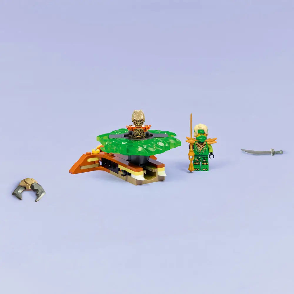 LEGO NINJAGO spinner build is displayed with a green translucent spinning base, earth monster figure, and Lloyd minifigure holding a gold sword, arranged neatly on a plain light background.
