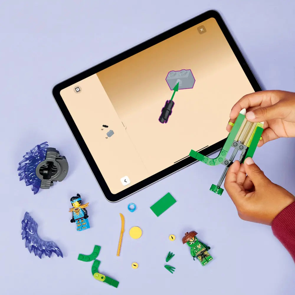 LEGO NINJAGO spinner parts in green and blue plastic are arranged on a tabletop while a child builds the launcher and spinner, surrounded by loose elements, weapons, and a tablet showing guided instructions.