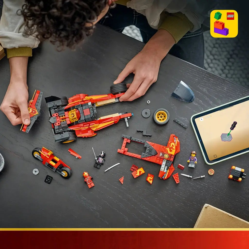 LEGO NINJAGO X-1 Ninja Charger parts in red, black and gold plastic cover a dark tabletop as a builder assembles the car beside a tablet showing digital instructions.