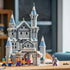 LEGO One Piece Battle at Drum Castle display features gray plastic walls, blue-gray turret roofs, snowy details, an arched gateway, and six minifigures on a cork tabletop.