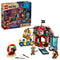 LEGO ONE PIECE Buggy the Clown's Circus Tent set in red, white, blue and gray plastic with circus tent, Buggy, Luffy, Nami and Zoro minifigures, accessories and retail box on a white background.