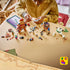 LEGO One Piece Dorry vs. Brogy build shows brown and tan brick-built giants, loose plastic pieces, character figures, white scenery, and a digital guide on a tabletop.