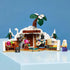 LEGO One Piece Dr. Hiriluk's Hideout in white, brown and green plastic features a snowy cave room, flowering tree, fireplace, bed and three minifigures on a blue display.