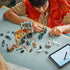 LEGO One Piece playset in gray, tan, orange and green plastic shows a smiling builder moving the motorcycle beside the Recruitment Center, stall and minifigures.