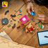 LEGO One Piece Tony Tony Chopper build scene shows a brown and pink brick-built figure, blue backpack parts, medicine accessories, loose pieces, and a tablet guide on wood.