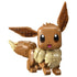 LEGO Pokémon Eevee collectible figure features brown and cream plastic bricks, a rounded fox-like character form with large pointed ears, fluffy collar and curled tail on a studio background.