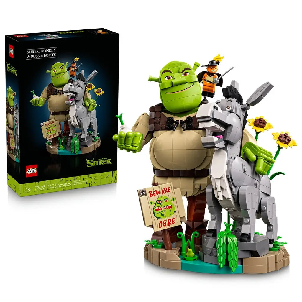 LEGO Shrek display set pairs its black retail box with green Shrek, gray Donkey and orange Puss in Boots brick figures on a detailed swamp-themed display base.