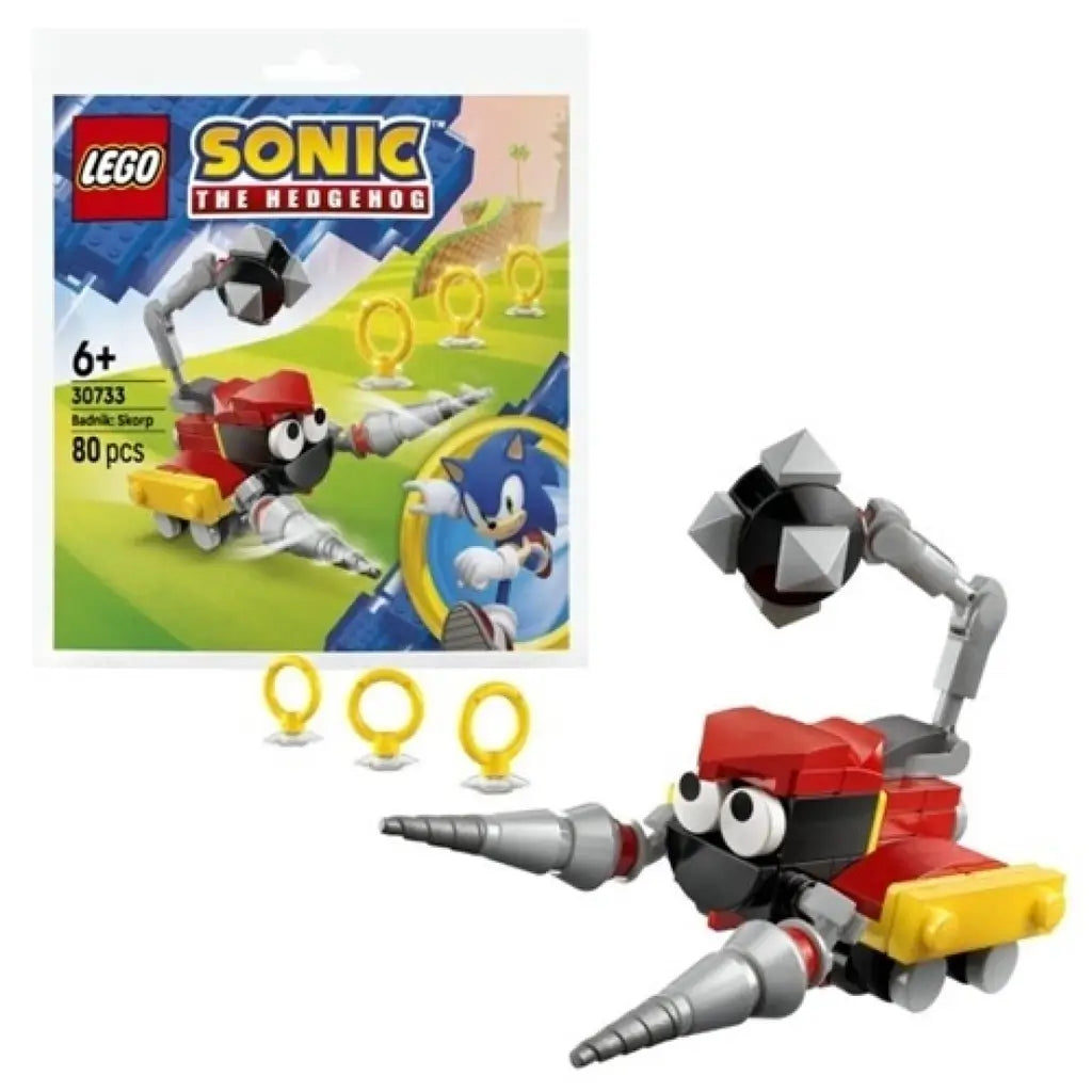 LEGO Sonic the Hedgehog Badnik Skorp building set featuring red, black, gray, and yellow plastic robot with drill arms and tail beside the branded 30733 foil pack on a clean white background.
