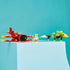 LEGO Sonic the Hedgehog Tails' Tornado-1 display features a red and yellow brick airplane, Tails figure, green Badnik robot and small accessory arranged on a light blue pedestal.