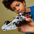 LEGO Audi F1 race car toy in gray, black, and red plastic, sleek Formula 1 shape, held by child for play, showcasing realistic wheels and cockpit detail against a soft neutral indoor background.