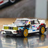 LEGO Speed Champions BMW M3 E30 in white and black plastic features gold wheels, yellow headlights and colorful racing graphics, displayed on a reflective indoor surface.
