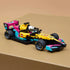 LEGO Speed Champions race car, yellow black pink and teal plastic Formula 1 model with low aerodynamic shape and racing tires, displayed on a tan platform against a soft neutral background.