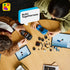 LEGO Speed Champions building set in blue and black plastic is assembled by a child and adult on a wooden table with loose wheels, pieces, minifigures and two tablets.