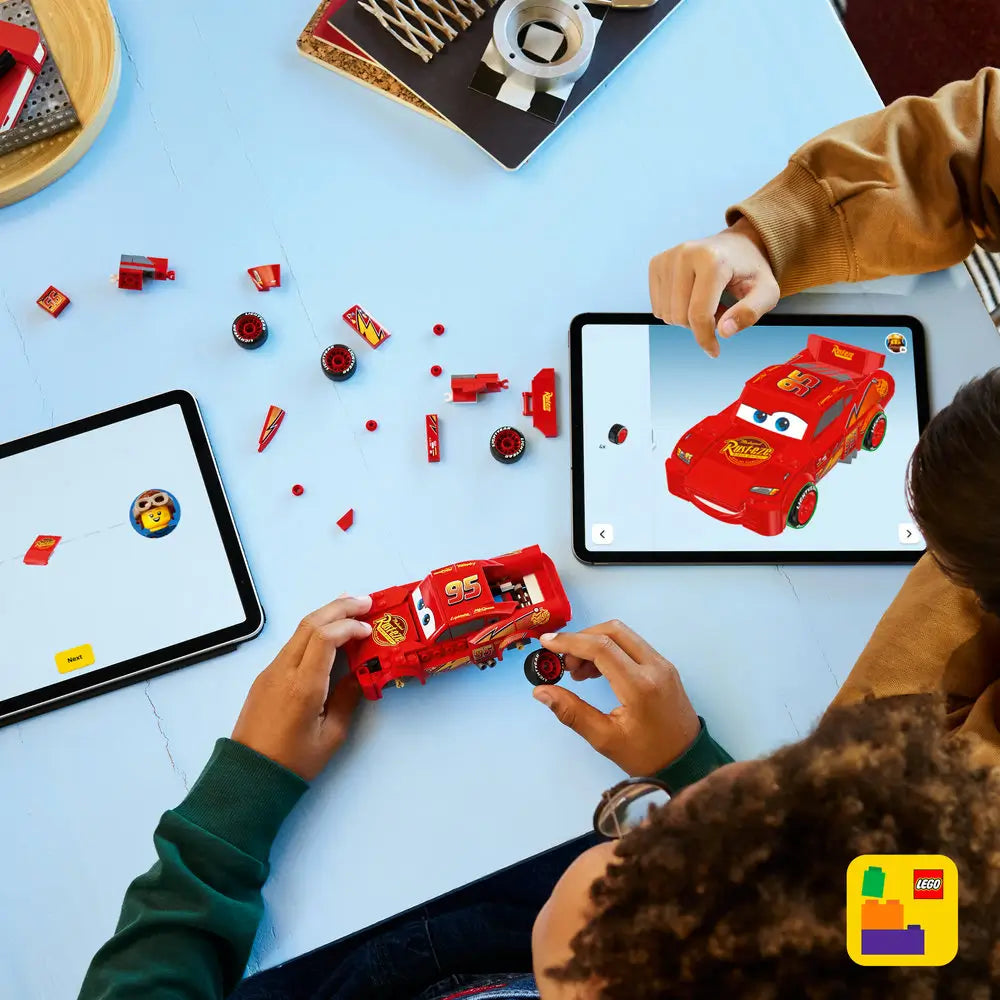 LEGO Lightning McQueen Speed Champions car shown from multiple angles in glossy red plastic with printed facial details, racing decals, rear spoiler, and stylized proportions inspired by the Cars movie design