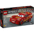 LEGO Speed Champions Lightning McQueen box front in black packaging, featuring the red race car model on a racetrack backdrop with Disney Pixar Cars branding, age rating, and piece count clearly visible