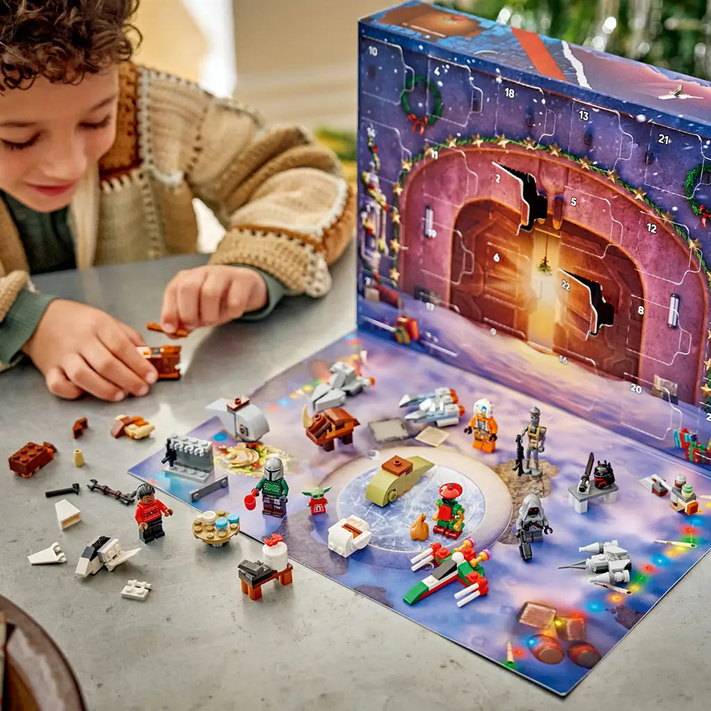 LEGO Star Wars Advent Calendar 2026 playset is assembled by a child at a table, with colorful minifigures, starships and mini builds spread before numbered calendar doors.