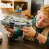 LEGO Star Wars Anzellan Starship model features a gray plastic spacecraft with rounded engines and yellow accent details, held by a child in a home setting while imagining flight adventures.