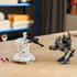 LEGO Star Wars AT-RT Attack display features a gray plastic walker, white cylindrical turret and character minifigures arranged for battle play on a wooden tabletop indoors.