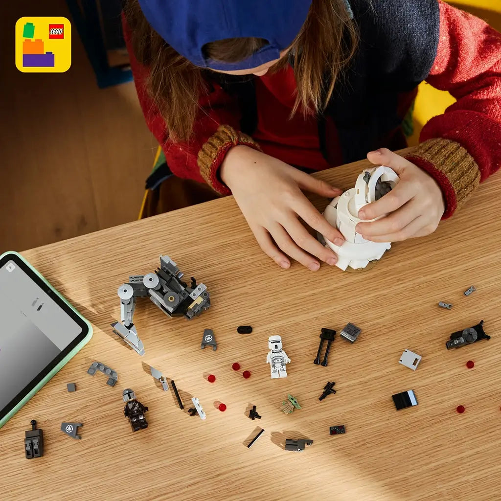 LEGO Star Wars AT-RT Attack toy features a child playing with a gray articulated walker, white turret structure and character figures, highlighting interactive battle-themed storytelling.