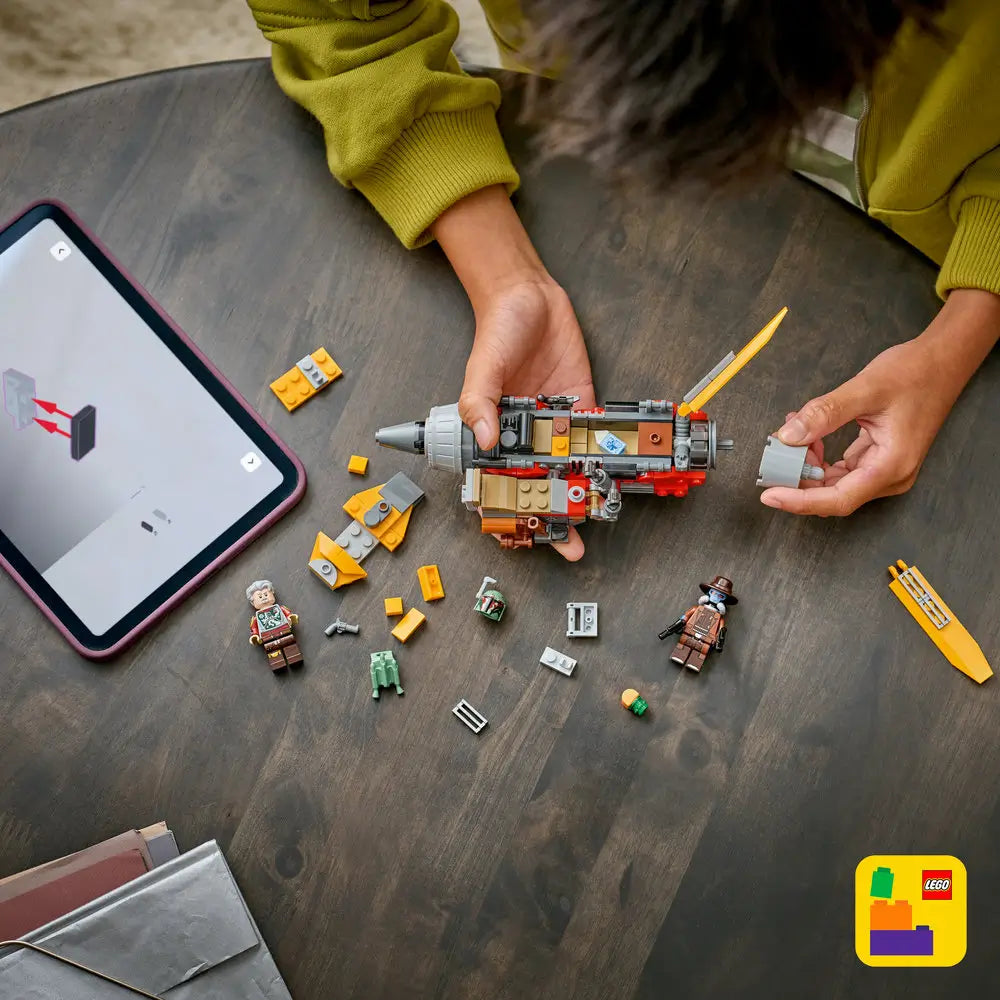 LEGO Star Wars speeder in yellow, red, and gray plastic with a compact, mechanical shape, shown partially disassembled during play to highlight modular building features on a dark tabletop setting.