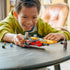 LEGO Star Wars speeder play scene in yellow, red, and gray plastic, held by a smiling child indoors, emphasizing hands-on building, imaginative play, and character interaction.