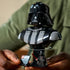 LEGO Star Wars Darth Vader bust features glossy black plastic armor panels, a sculpted rotating helmet display, character plaque and minifigure, demonstrated in a tabletop setting.